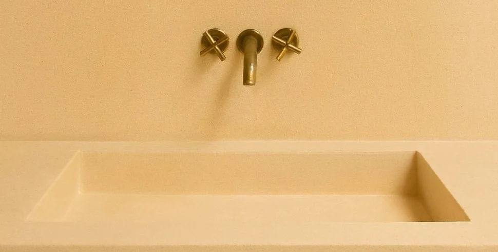 A bathroom with microcement walls, floor and shower area.